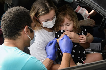 University Health team member placing a band aid on patient.