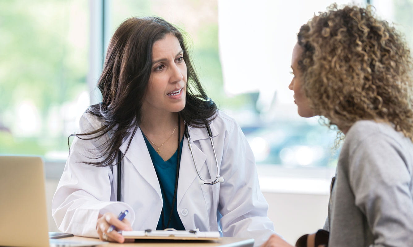 Doctor talking to female patient