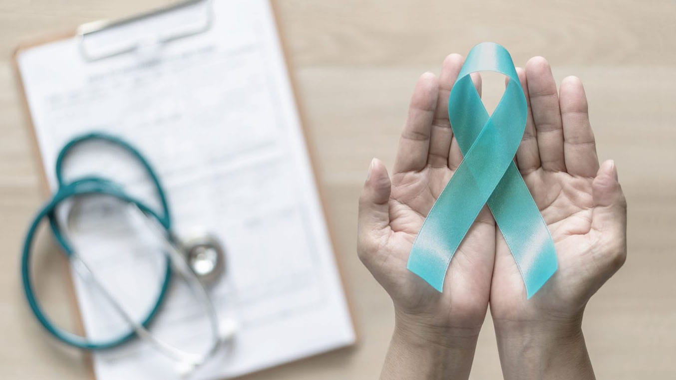 Hands holding a teal ribbon