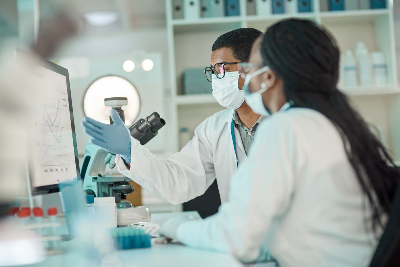 Two researchers sitting at a desk in a laboratory