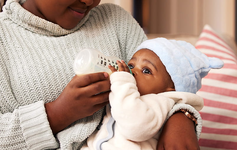 A mother bottle feeds a baby.
