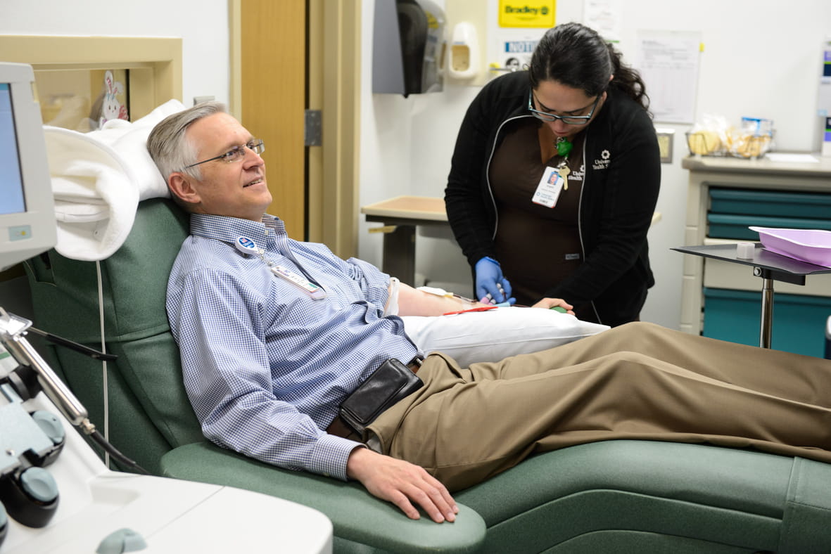 Man donating blood in the blood donor clinic at University Health.