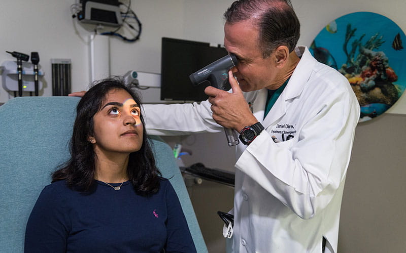 University Health provider checking on patient in emergency department