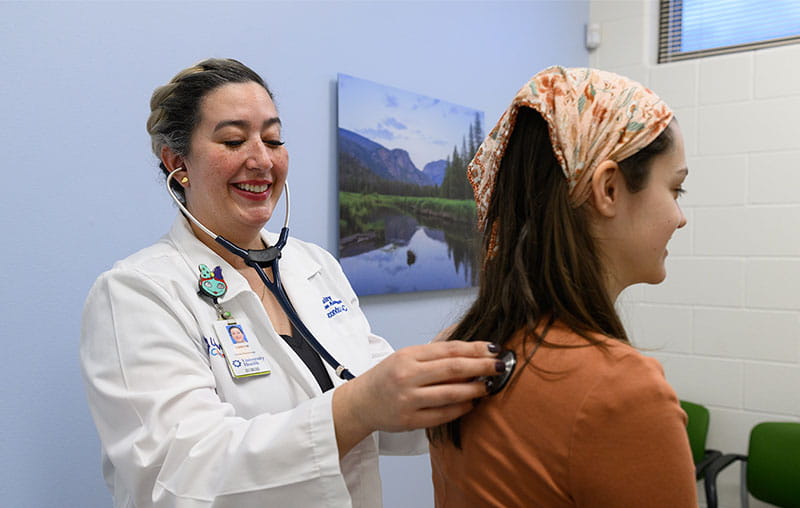 University Health family nurse practitioner, Leanne Ricondo, checking the lung function of female patient.