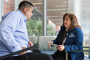 A nurse is speaking with a patient.