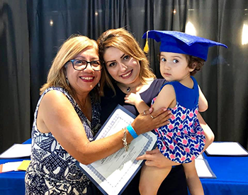 Nurse Patty and Alma, a teen mom, celebrating Alma's child's kinder graduation.