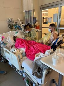 Hospital room with the family and child inside