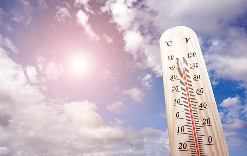 Thermometer against a backdrop of a sunny sky