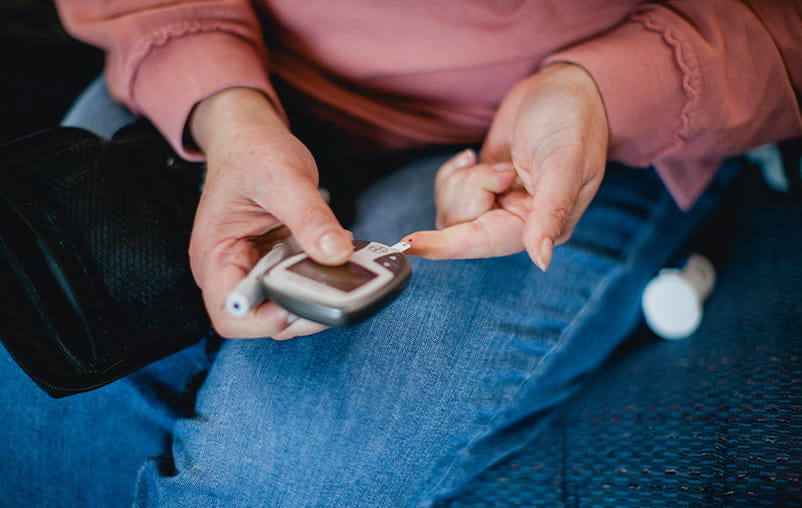 A woman checks her blood sugar levels.