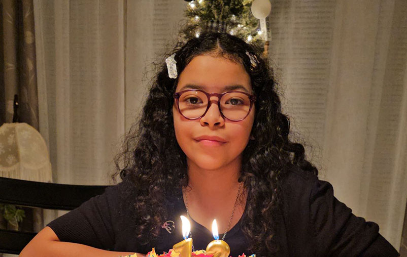 Aleyna Rodriguez's 12th birthday photo at her dinner table with her birthday cake.