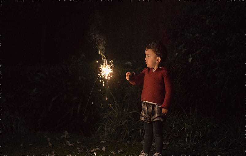 Boy holding sparklers for New Year's Eve