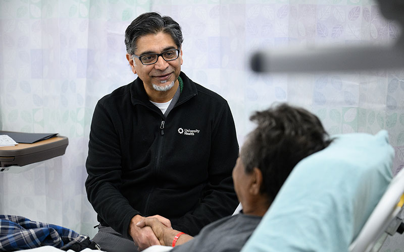 University Health Gastroenterologist, Dr. Sandeep Patel discussing an advanced endoscopic procedure with patient.