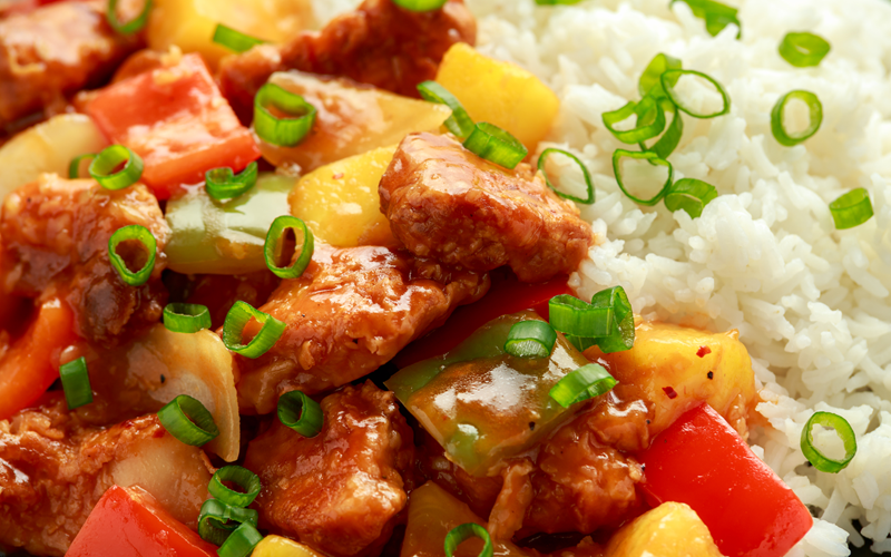 Pineapple and chicken in a sweet-and-spicy sauce with bell peppers and rice.