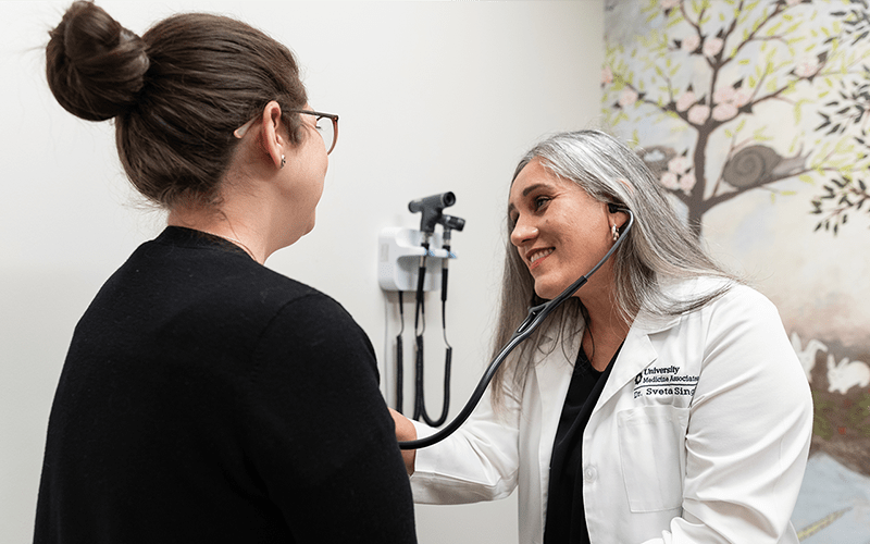 University Health physician, Sveta Singh, is checking on a female patient at University Health Huebner Commons. 